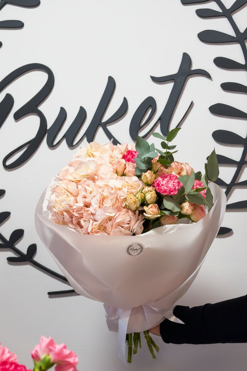 Red and pink roses bouquet in white wrap