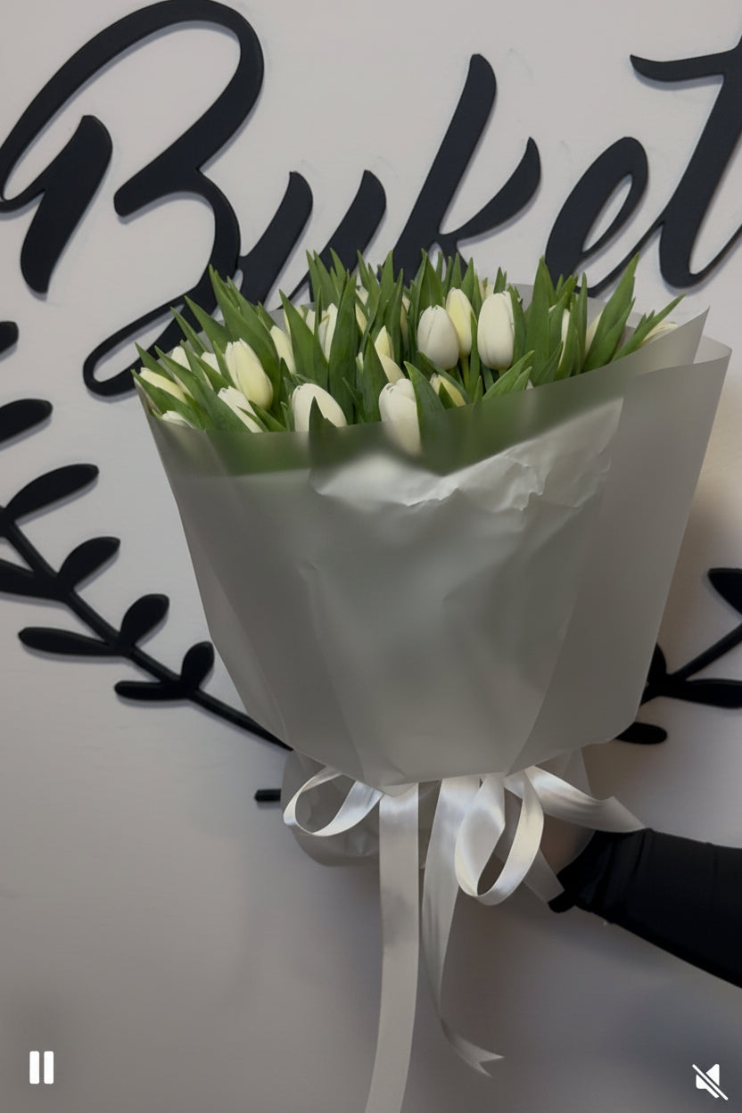 Peony roses and gypsophila bouquet in pink wrap