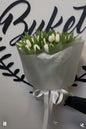 Peony roses and gypsophila bouquet in pink wrap