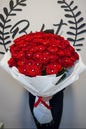 Red roses with crystal diamonds bouquet in white wrap